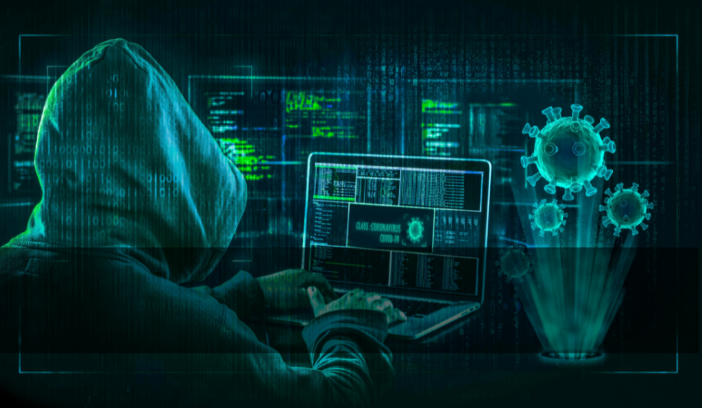 Person in a hoodie typing on a computer and a drawing of the Covid-19 virus.