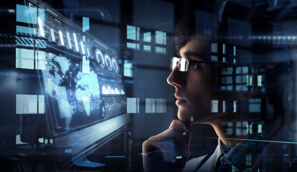 Guy wearing glasses sitting in front of computer.
