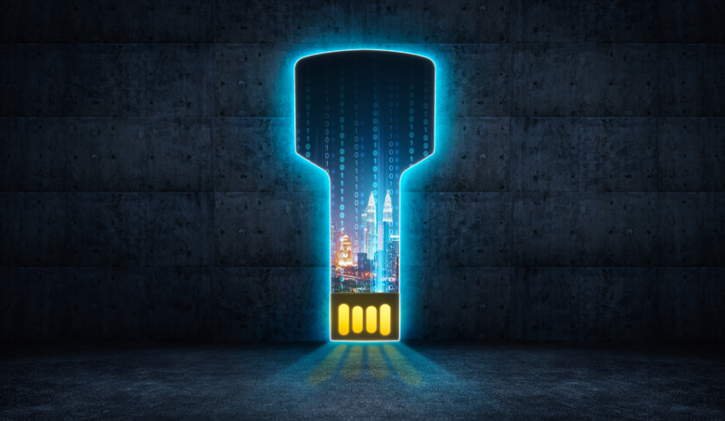 A USB that looks like a key with zero's, one's and buildings on it.