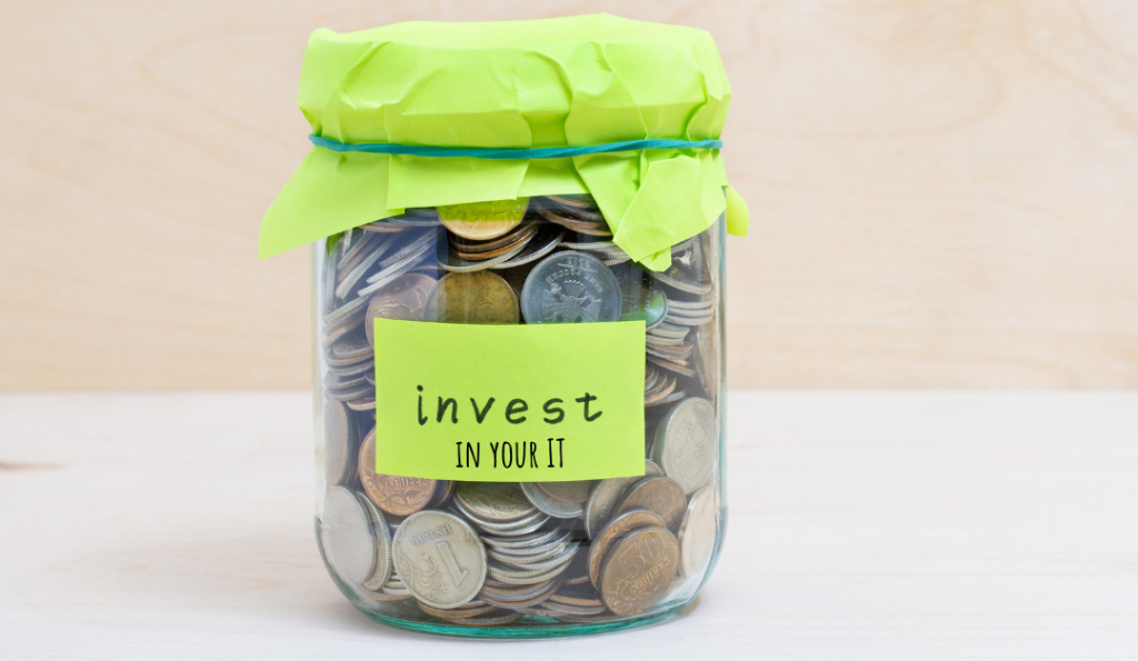 Jar with coins inside using green paper as a lid. On the jar is a piece of paper saying "invest in your IT".